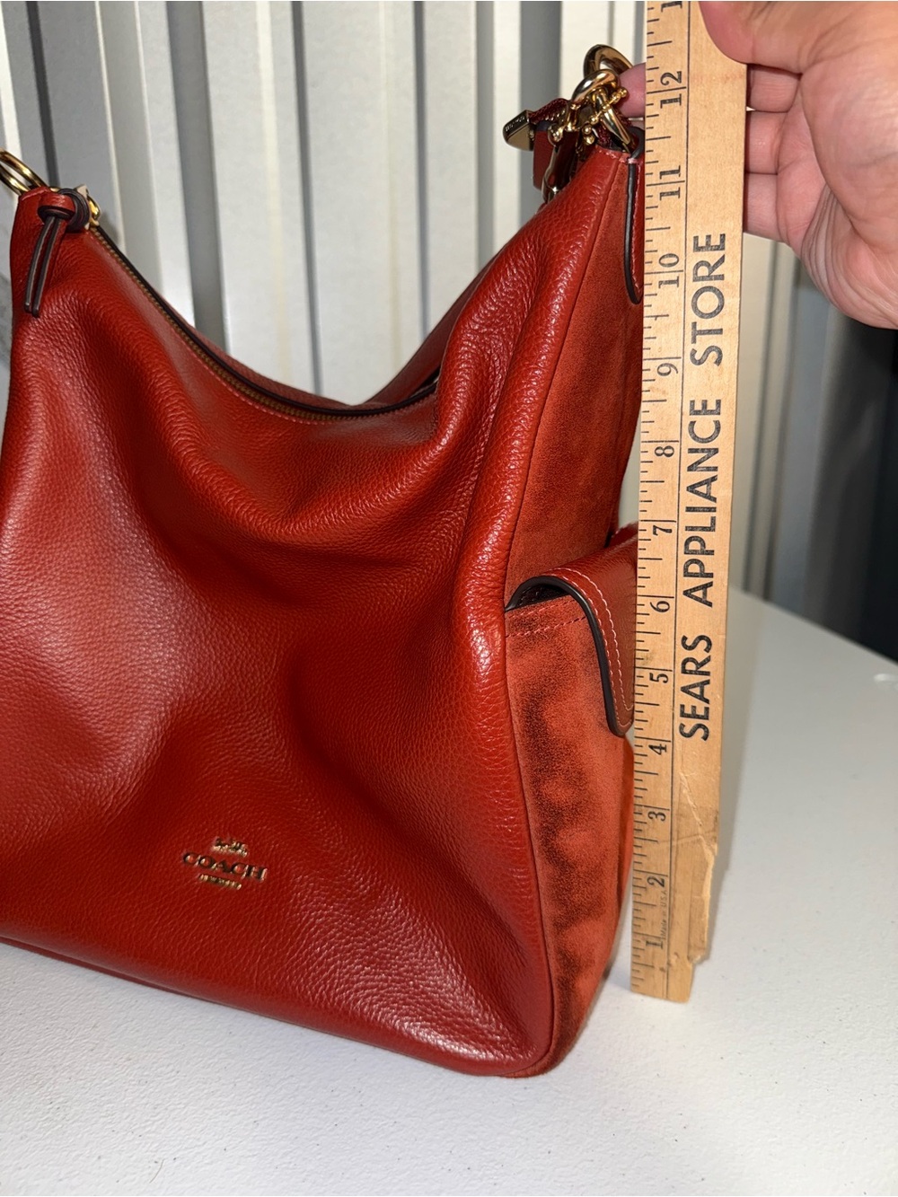 Coach Pennie Shoulder Bag features gold hardware and side suede pockets - Picture 14 of 15